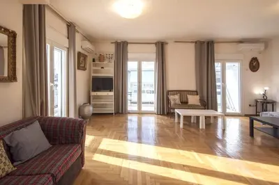 a living room with a couch and a table at Home away from Home in Athens