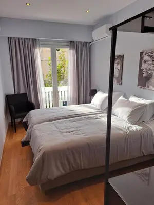a bedroom with a large bed and a window at TrilogyCentral in Athens