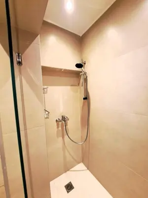 a bathroom with a shower with a glass door at TrilogyCentral in Athens