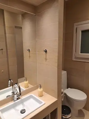 a bathroom with a sink and a toilet at TrilogyCentral in Athens