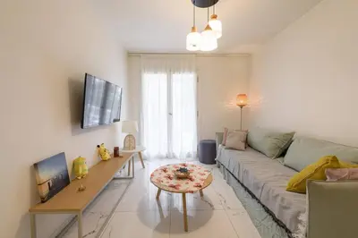 a living room with a couch and a table at Zeus1 beach front appatment, 1BR sea view in Athens