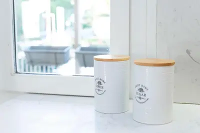 two white styrofoam cups sitting next to a window at Zeus2 Beach Front Apartment, 3BR in Athens
