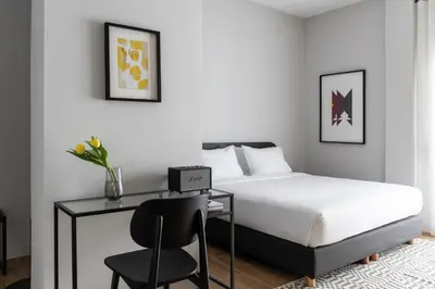 a bedroom with a bed and a desk and a chair at Elliot Petralona, Athens in Athens