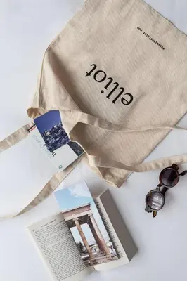 a bag with the word tours on it next to a magazine at Elliot Petralona, Athens in Athens