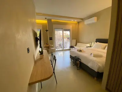 a bedroom with a bed and a table and a desk at Stairway to Lycabettus in Athens