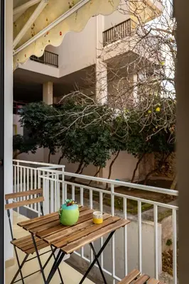 a wooden table on the balcony of a building at Stairway to Lycabettus in Athens