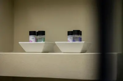 a shelf with two bottles and bowls on it at Stairway to Lycabettus in Athens