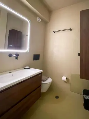 a bathroom with a sink and a toilet and a mirror at Stairway to Lycabettus in Athens
