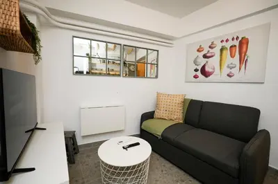 a living room with a couch and a table at The Extravagant studio in Pagkrati, Near Stadium in Athens