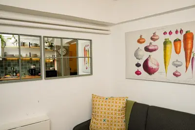 a living room with a couch and a mirror at The Extravagant studio in Pagkrati, Near Stadium in Athens