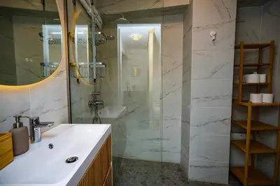 a bathroom with a sink and a shower at The Extravagant studio in Pagkrati, Near Stadium in Athens