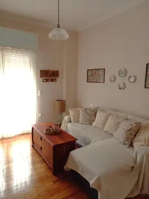 a living room with a couch and a table at Apartment Ioanneta - Vintage decorated, city center, close to metro station in Athens