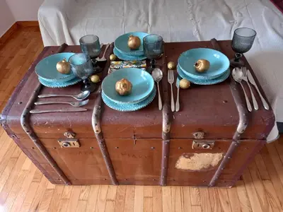 a table with plates and utensils on top of a trunk at Apartment Ioanneta - Vintage decorated, city center, close to metro station in Athens
