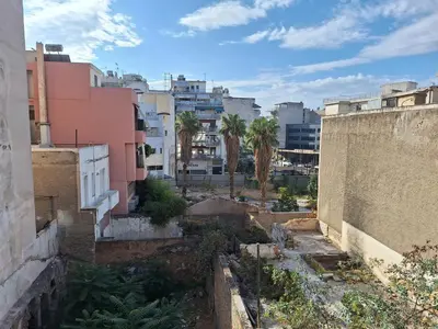a view of a city with buildings and palm trees at Apartment Ioanneta - Vintage decorated, city center, close to metro station in Athens