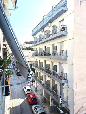an apartment building with cars parked outside of it at Apartment Ioanneta - Vintage decorated, city center, close to metro station in Athens