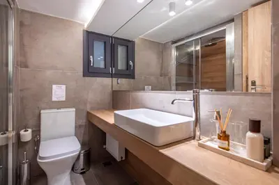 a bathroom with a sink and a toilet at Phaedrus Living Pagkrati Modern Grove in Athens