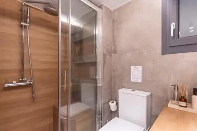 a shower stall in a bathroom with a toilet at Phaedrus Living Pagkrati Modern Grove in Athens