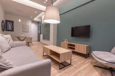 a living room with a couch and a tv at Phaedrus Living Pagkrati Modern Grove in Athens