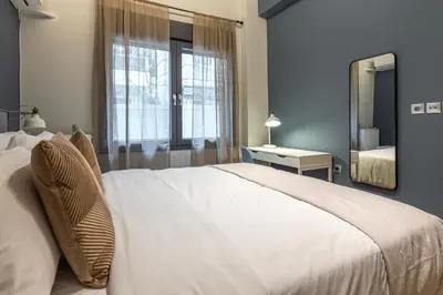 a bedroom with a large white bed and a mirror at Phaedrus Living Pagkrati Modern Grove in Athens