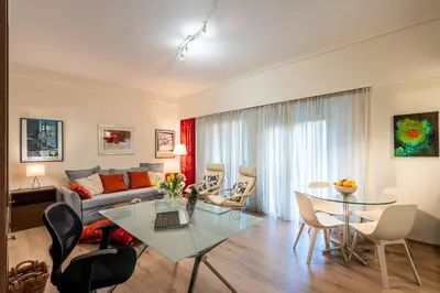 a living room with a couch and a table at Didotου Apartments in Athens