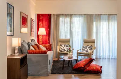a living room with a couch and two chairs at Didotου Apartments in Athens