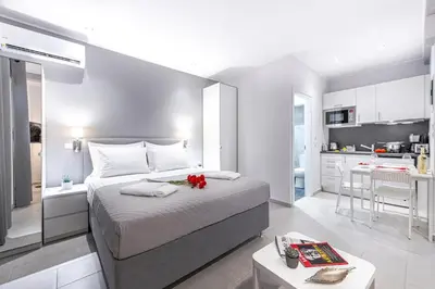 a bedroom with a large bed and a kitchen at Athens Central-Opulent and Luxurious Suites-Balcony & Views Acropolis Hills in Athens