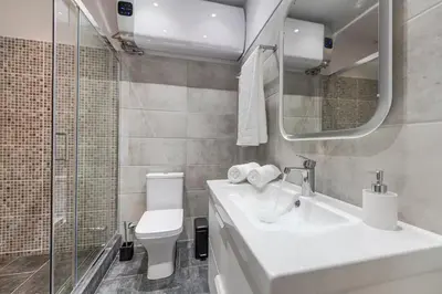 a bathroom with a sink and a toilet and a mirror at Athens Central-Opulent and Luxurious Suites-Balcony & Views Acropolis Hills in Athens