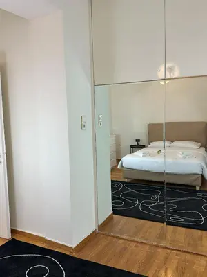 a bedroom with a bed and a glass wall at Acropolis Elegant Apartment II in Athens