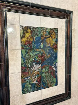 a mosaic tile wall with a painting on it at Acropolis Elegant Apartment II in Athens