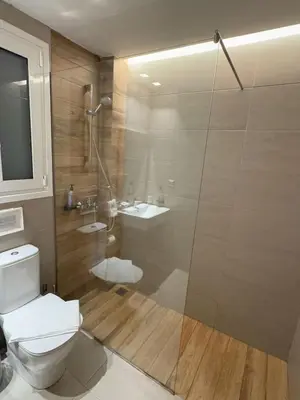 a bathroom with a shower and a toilet and a sink at Urban Muse Apartments - Archaeological Museum of Athens in Athens