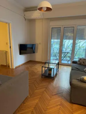a living room with a couch and a table at Urban Muse Apartments - Archaeological Museum of Athens in Athens