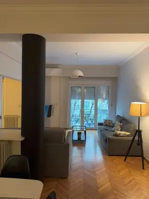 a living room with a couch and a table at Urban Muse Apartments - Archaeological Museum of Athens in Athens