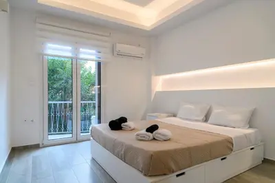 two stuffed animals sitting on a bed in a bedroom at Icarus Minimal 2bedroom Bliss in Athens