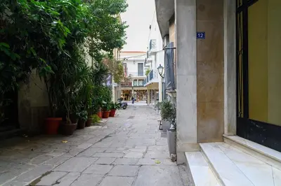 an empty street with plants on the side of a building at Icarus Minimal 2bedroom Bliss in Athens
