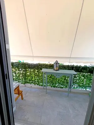 a table in a tent with a box on it at Apartment next to the sea in Anavissos