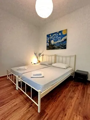 a bedroom with a large bed with a white frame at Apartment next to the sea in Anavissos