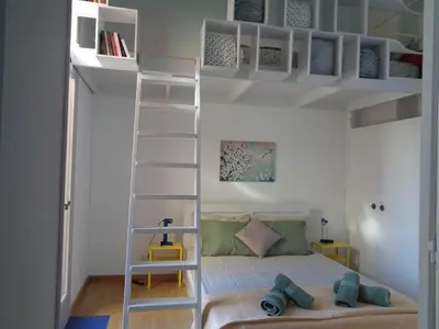 a bedroom with a bunk bed and a ladder at Σπίτι - Κάστρο πάνω από τη θάλασσα in Piraeus