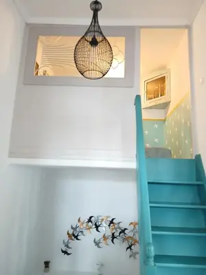 a room with a staircase and a chandelier at Σπίτι - Κάστρο πάνω από τη θάλασσα in Piraeus