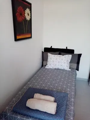 a bedroom with a bed with two towels on it at Σπίτι - Κάστρο πάνω από τη θάλασσα in Piraeus