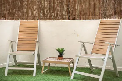 two chairs with a potted plant sitting between them at Charming Apartment near Acropolis 100mbps WiFi in Athens