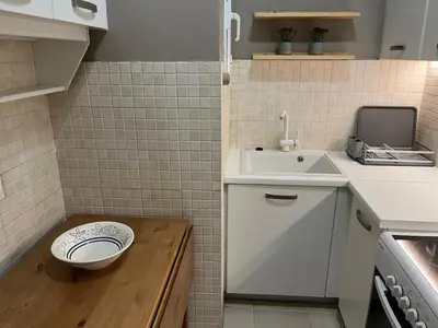 a small bathroom with a toilet and a sink at Acropolis, 2BD Erechthiou 21 23 in Athens