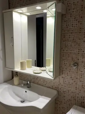 a bathroom with a white sink and a mirror at Acropolis, 2BD Erechthiou 21 23 in Athens