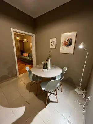 a dining room with a white table and chairs at Acropolis, 2BD Erechthiou 21 23 in Athens