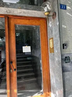 a wooden door with a sign on top of it at Acropolis, 2BD Erechthiou 21 23 in Athens