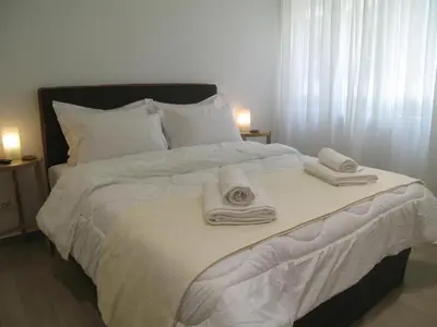 a white bed with towels and pillows on it at Parthenonas in Athens