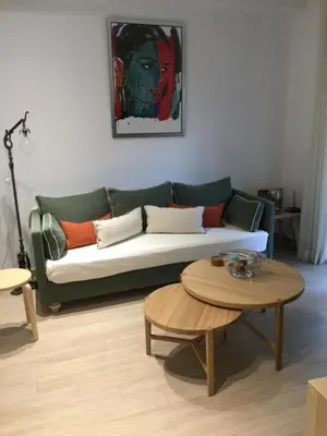 a living room with a green couch and a table at Parthenonas in Athens