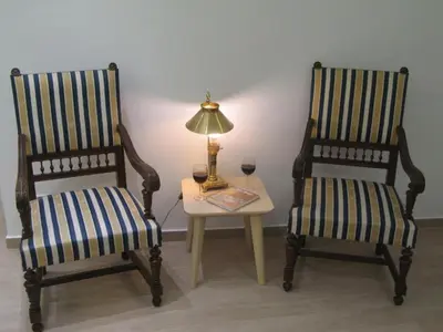 two chairs sitting next to a table with a lamp at Parthenonas in Athens