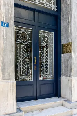 a blue door of a building with gold gate at Florant in Athens