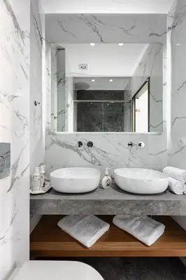 a white bathroom with two sinks and a mirror at Florant in Athens