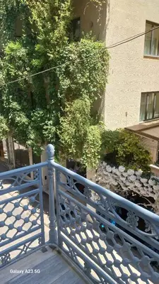 a blue railing on a walkway with a building at Florant in Athens